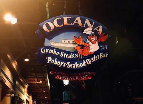 Sign for Oceana Restaurant featuring a chef crab, promoting gumbo, steaks, poboys, and seafood. Established in 1973.