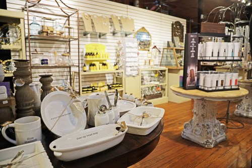 A cozy retail space featuring decorative home goods, kitchenware, and various accessories on display.