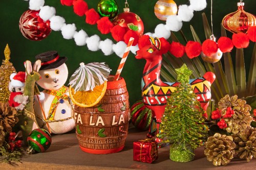 A festive display featuring a colorful drink, holiday decorations, and cheerful figurines, creating a joyful holiday atmosphere.
