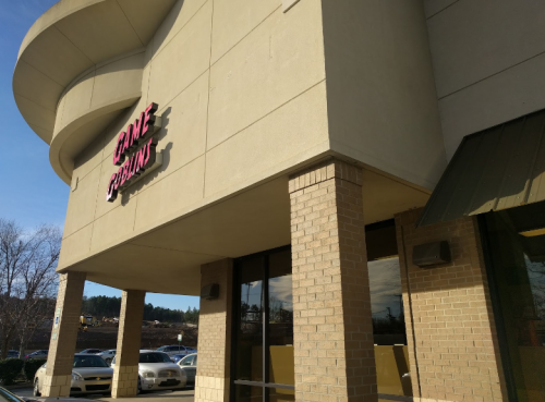 Exterior of a building with a sign that reads "Game Points," featuring a modern architectural design.
