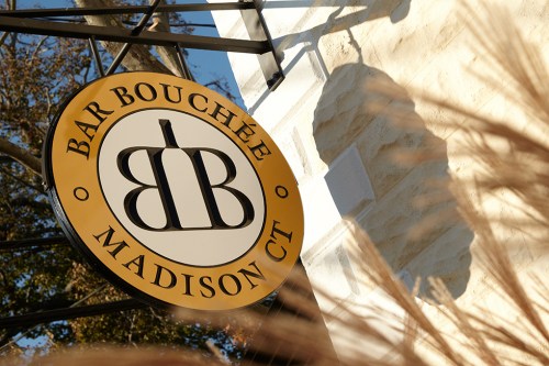 Sign for Bar Bouchée in Madison, CT, featuring a circular design with the letters "BB" in the center.