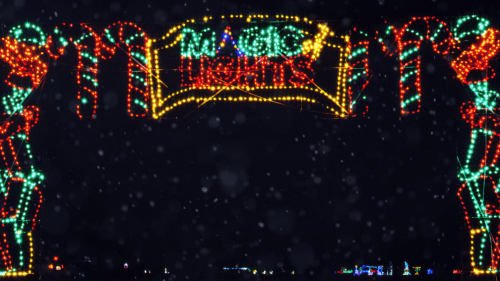 Colorful holiday lights form an archway with "Magic Lights" illuminated against a dark background. Snowflakes are falling.