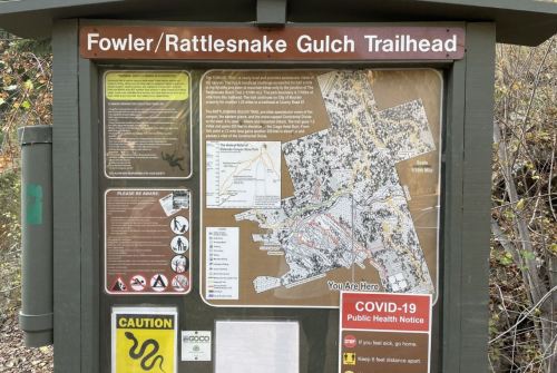 Trailhead sign for Fowler/Rattlesnake Gulch, featuring a map and safety information, including a COVID-19 notice.