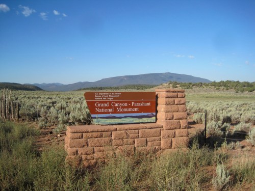 Sign for Grand Canyon-Parashant National Monument in a desert landscape with mountains in the background.