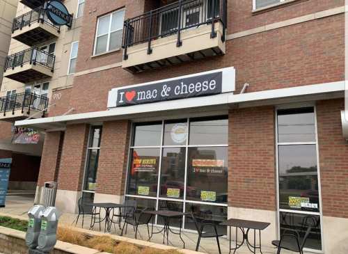 Exterior of a restaurant named "I Love Mac & Cheese," featuring large windows and outdoor seating.