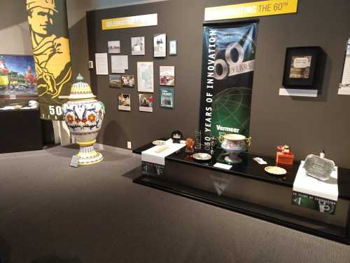 Exhibit showcasing historical artifacts and displays celebrating 60 years of innovation, with decorative items and information panels.