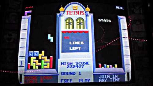 A retro Tetris game screen displaying blocks, high score, and game stats on an arcade-style interface.