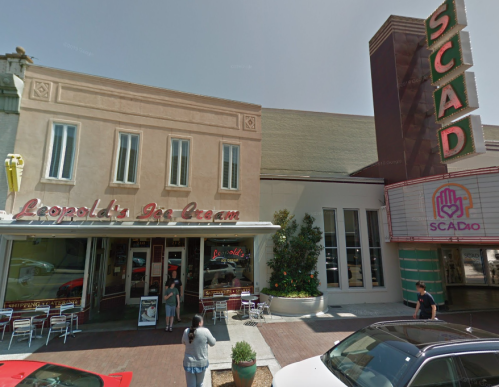 A street view of Leopold's Ice Cream shop next to SCAD, featuring outdoor seating and a vibrant storefront.