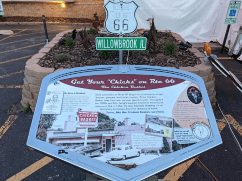 Sign for Route 66 in Willowbrook, IL, featuring a historical marker about the Chicken Basket restaurant.