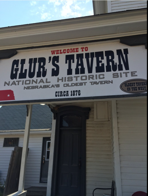 Sign for Glur's Tavern, Nebraska's oldest tavern, with "Welcome" and "National Historic Site" displayed prominently.