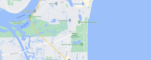 Map showing coastal parks and recreational areas near a body of water, with roads and landmarks labeled.