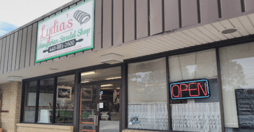 Exterior of Lydia's Hungarian Strudel Shop, featuring a sign that says "OPEN" and a welcoming storefront.