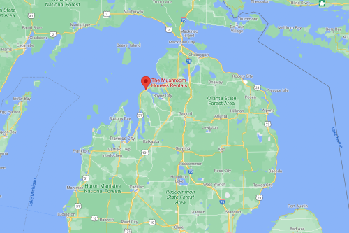 Map showing the location of The Mushroom House Rentals in northern Michigan, near Lake Michigan and surrounding forests.