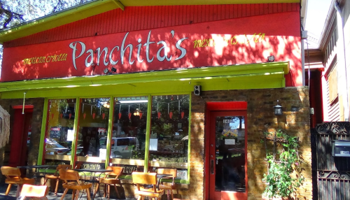Exterior of Panchita's restaurant, featuring colorful signage and outdoor seating under a bright, sunny sky.