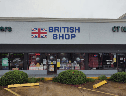 Exterior of a British shop with a Union Jack flag sign, featuring an "Open" sign and a well-maintained storefront.