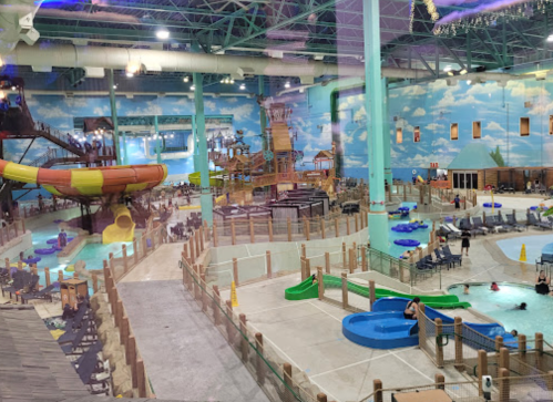 Indoor water park featuring slides, pools, and play areas, with colorful decor and families enjoying the attractions.