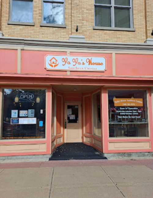 Front view of "Ya Ya's House," a Southern cuisine restaurant with an orange facade and open sign.