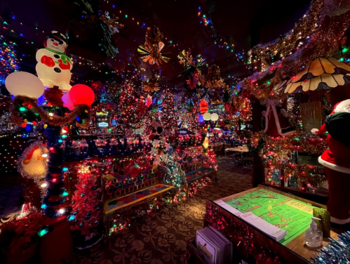 A vibrant, festive room filled with colorful Christmas lights, decorations, and holiday-themed ornaments.