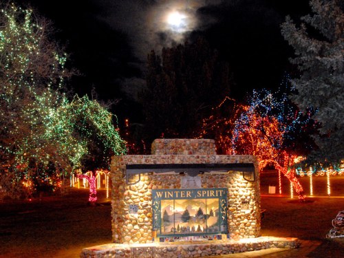 A stone sign reading "WINTER SPIRIT" surrounded by colorful holiday lights under a bright moonlit sky.