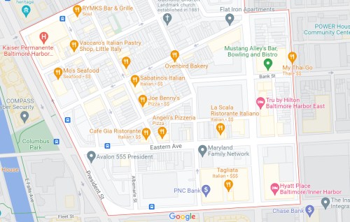 Map of a neighborhood featuring various restaurants, shops, and landmarks near Baltimore Harbor.