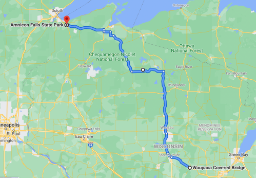Map showing a route from Waupaca Covered Bridge to Amnicon Falls State Park in Wisconsin, highlighting nearby forests.