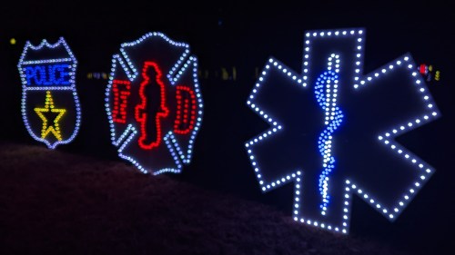 Colorful light displays representing police, fire, and medical services against a dark background.