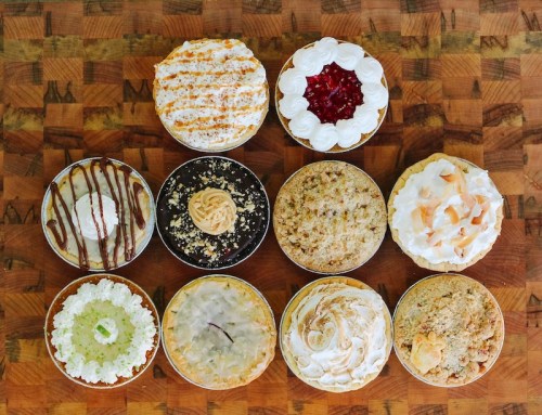 A variety of ten delicious desserts in small bowls, featuring different toppings and flavors, arranged on a wooden surface.