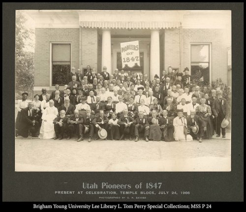 A large group of people gathered for the Utah Pioneers of 1847 celebration, July 24, 1906, in front of a building.