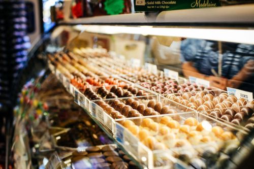 A display case filled with an assortment of colorful chocolates and confections.