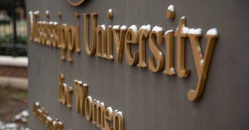 Sign for Mississippi University for Women, with snow lightly dusting the letters.