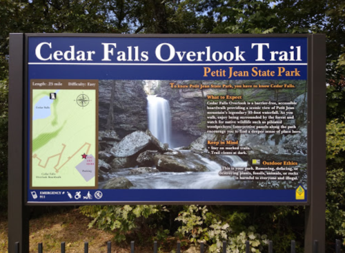 Sign for Cedar Falls Overlook Trail at Petit Jean State Park, featuring a map and information about the trail and waterfall.