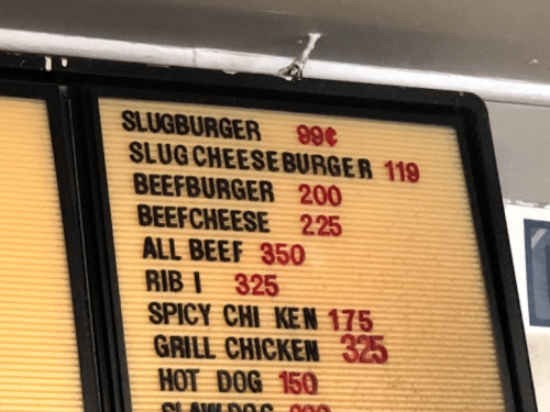 Menu board displaying various burgers and prices, including Slugburger, Beefburger, and Rib options.