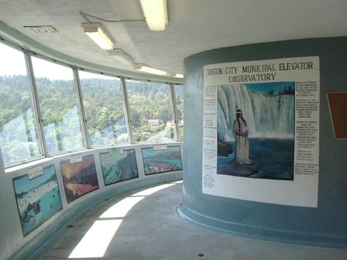 Interior view of the Oberon City Municipal Elevator Observatory, featuring a mural and scenic paintings of waterfalls.