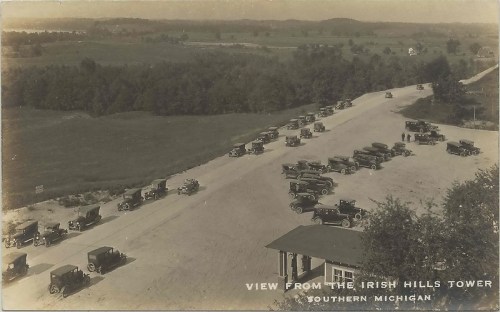 Aerial view of vintage cars parked along a road near the Irish Hills Tower in Southern Michigan.