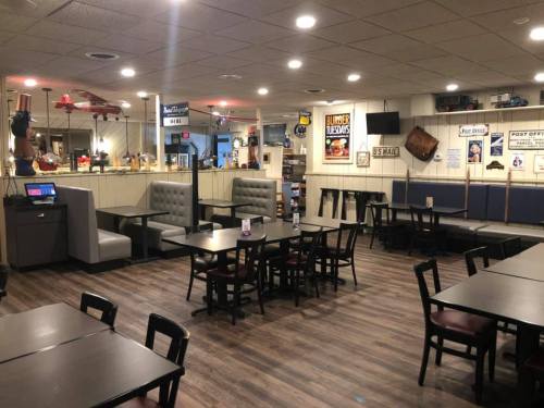 Cozy diner interior with booths, tables, and vintage decor, featuring a warm, inviting atmosphere.