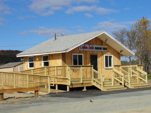 A wooden building with a sloped roof and multiple ramps, featuring a sign that reads "Coffee Joe's" against a blue sky.