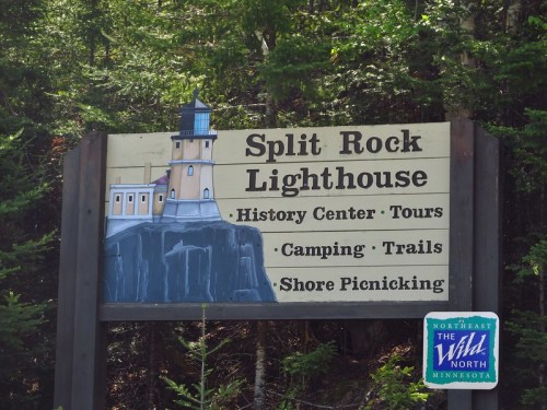 Sign for Split Rock Lighthouse featuring information on history center, tours, camping, trails, and shore picnicking.