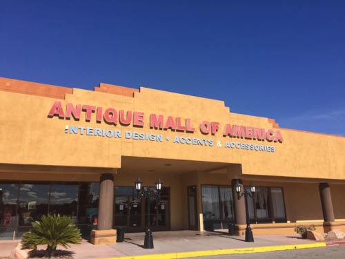 Exterior of the Antique Mall of America, featuring a bright sign and clear blue sky.