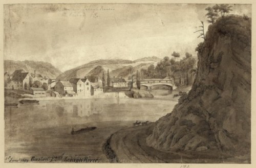 A sepia-toned landscape depicting a riverside village with buildings, a bridge, and hills in the background.