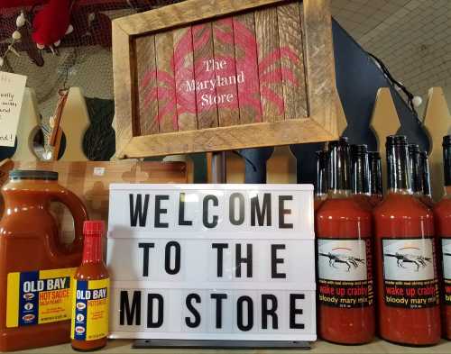 A display at a store featuring a sign that says "Welcome to the MD Store," with crab-themed products and sauces.