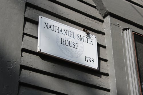 Sign for Nathaniel Smith House, established in 1798, mounted on a gray wooden wall.