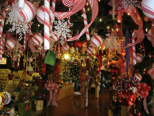 A festive shop decorated with red and white candy canes, ornaments, and snowflakes, creating a cheerful holiday atmosphere.