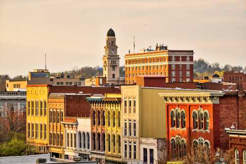 A scenic view of a historic downtown area with colorful buildings and a clock tower in the background.