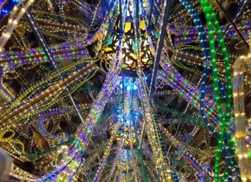 Colorful lights and intricate patterns create a dazzling display, resembling a vibrant, illuminated canopy.
