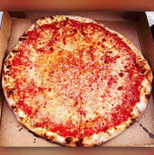 A large cheese pizza with a golden crust, cut into slices, in a cardboard pizza box.