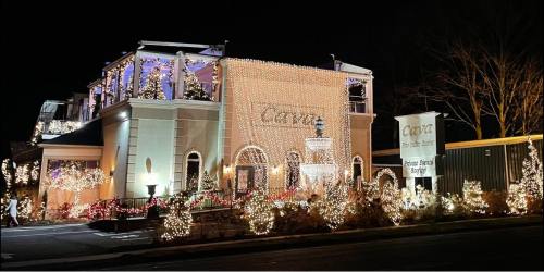 A beautifully lit building adorned with festive holiday lights and decorations at night.
