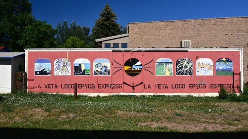 Colorful mural on a shipping container featuring various artistic designs and the text "LA VETA LOCO EPYCS EXPRESS."