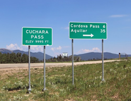 Two road signs: one for Cuchara Pass (elev. 9995 ft) and another directing to Cordova Pass (6 miles) and Aguilar (35 miles).