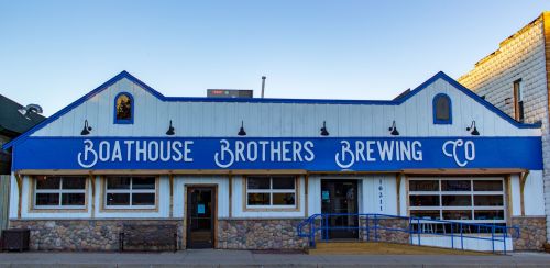 Exterior of Boathouse Brothers Brewing Co., featuring a blue facade with white lettering and stone accents.