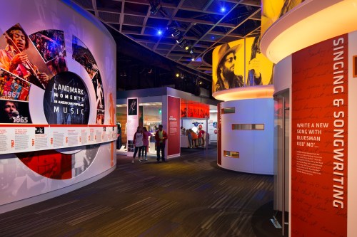 Interior of a music museum exhibit featuring displays on songwriting and landmark moments in music history.